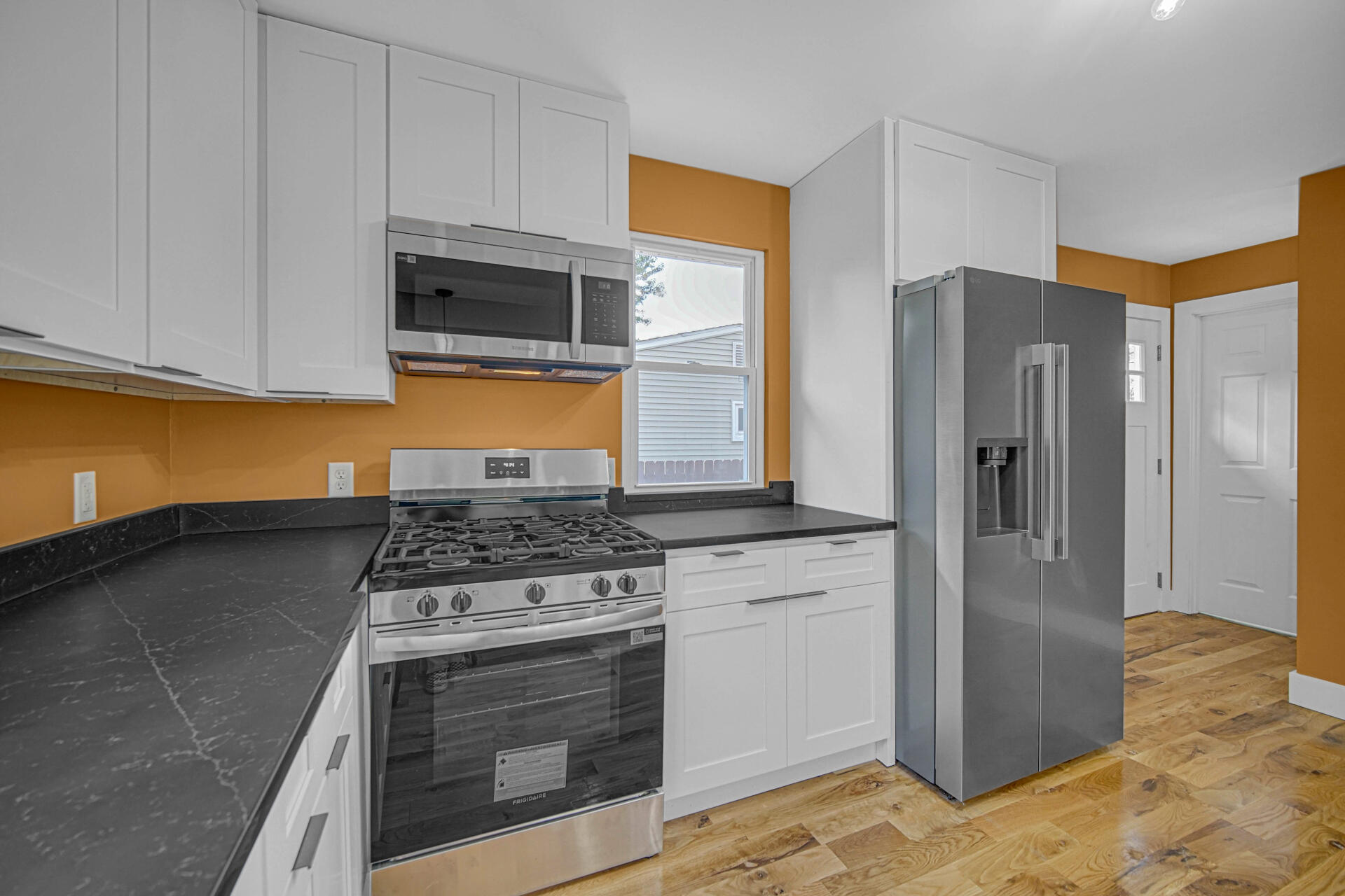 3015 West Ridge Road Hobart, IN 46342 - Photo 5 of 22 a kitchen with stainless steel appliances granite countertop a stove a refrigerator and a microwave