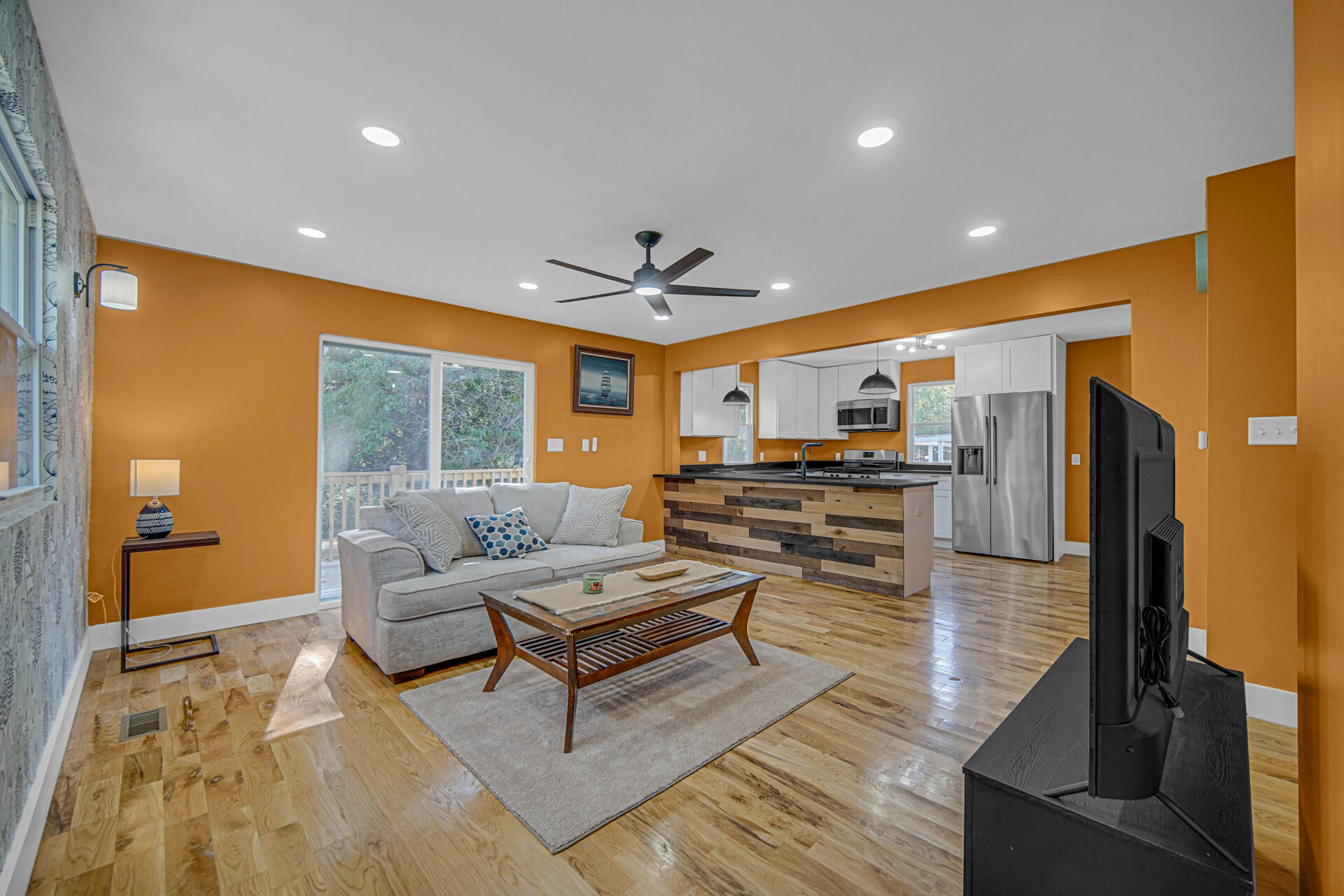 3015 West Ridge Road Hobart, IN 46342 - Photo 9 of 22 a living room with couches chairs and kitchen view with wooden floor