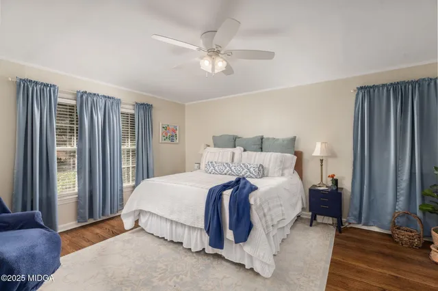 a spacious bedroom with a bed and a window