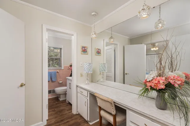 a bathroom with a sink mirror and toilet