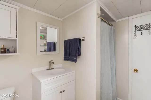 a bathroom with a sink toilet and mirror