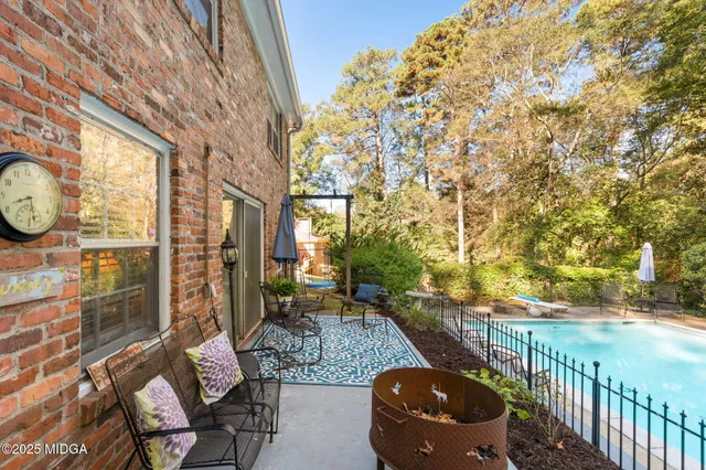 a backyard of a house with outdoor seating