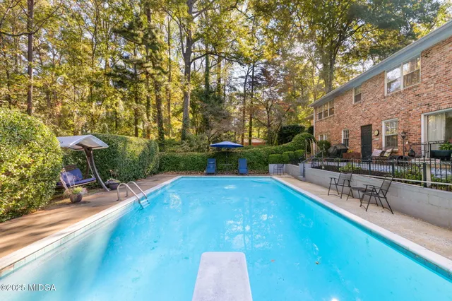 a view of a backyard with sitting area