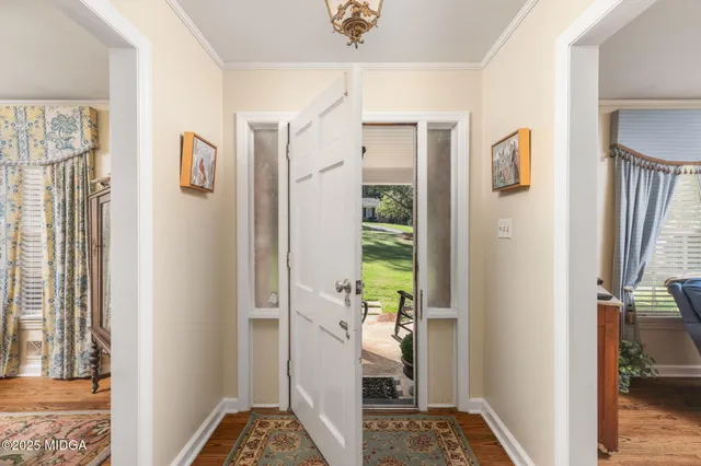 a view of a hallway with bathroom and front door