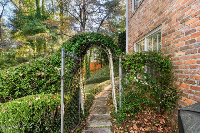 a view of a potted plants in front of brick house