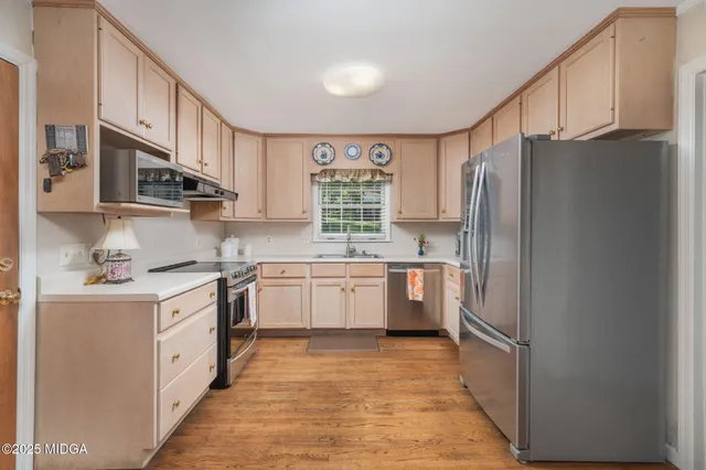 a kitchen with a refrigerator a sink and a stove