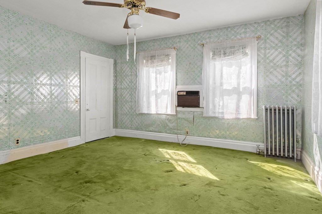 31 Andover Street Peabody, MA 01960 - Photo 20 of 40 a view of an empty room with chandelier fan and kitchen view