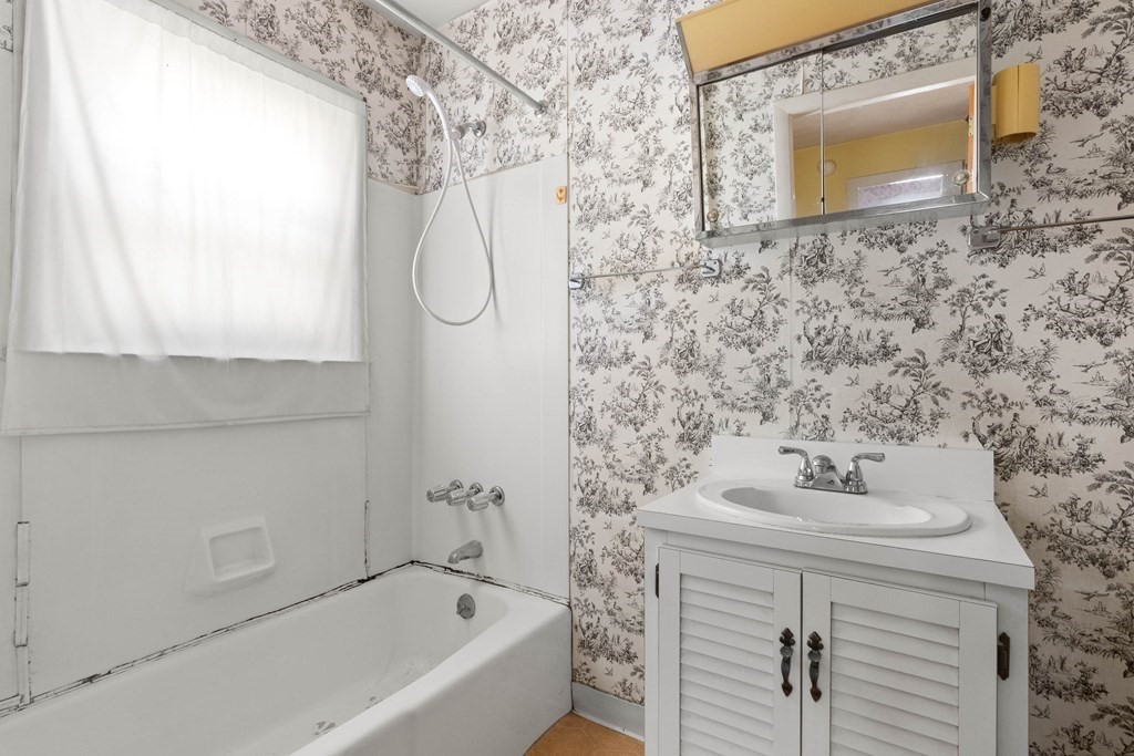 31 Andover Street Peabody, MA 01960 - Photo 31 of 40 a bathroom with a sink a mirror and a bathtub