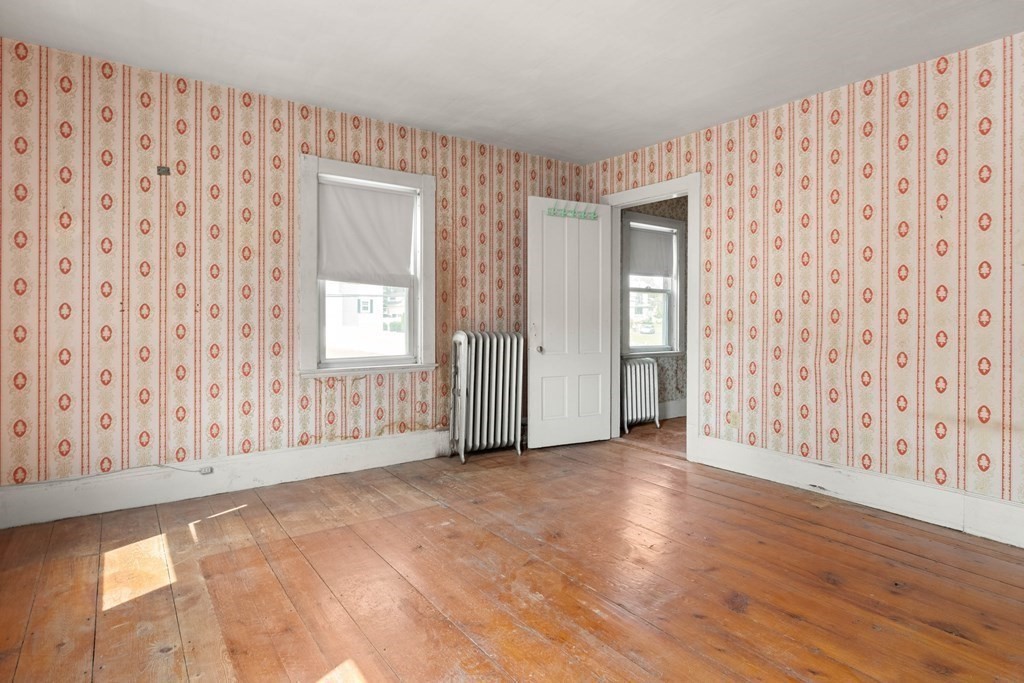 31 Andover Street Peabody, MA 01960 - Photo 33 of 40 a view of an empty room with wooden floor and a window