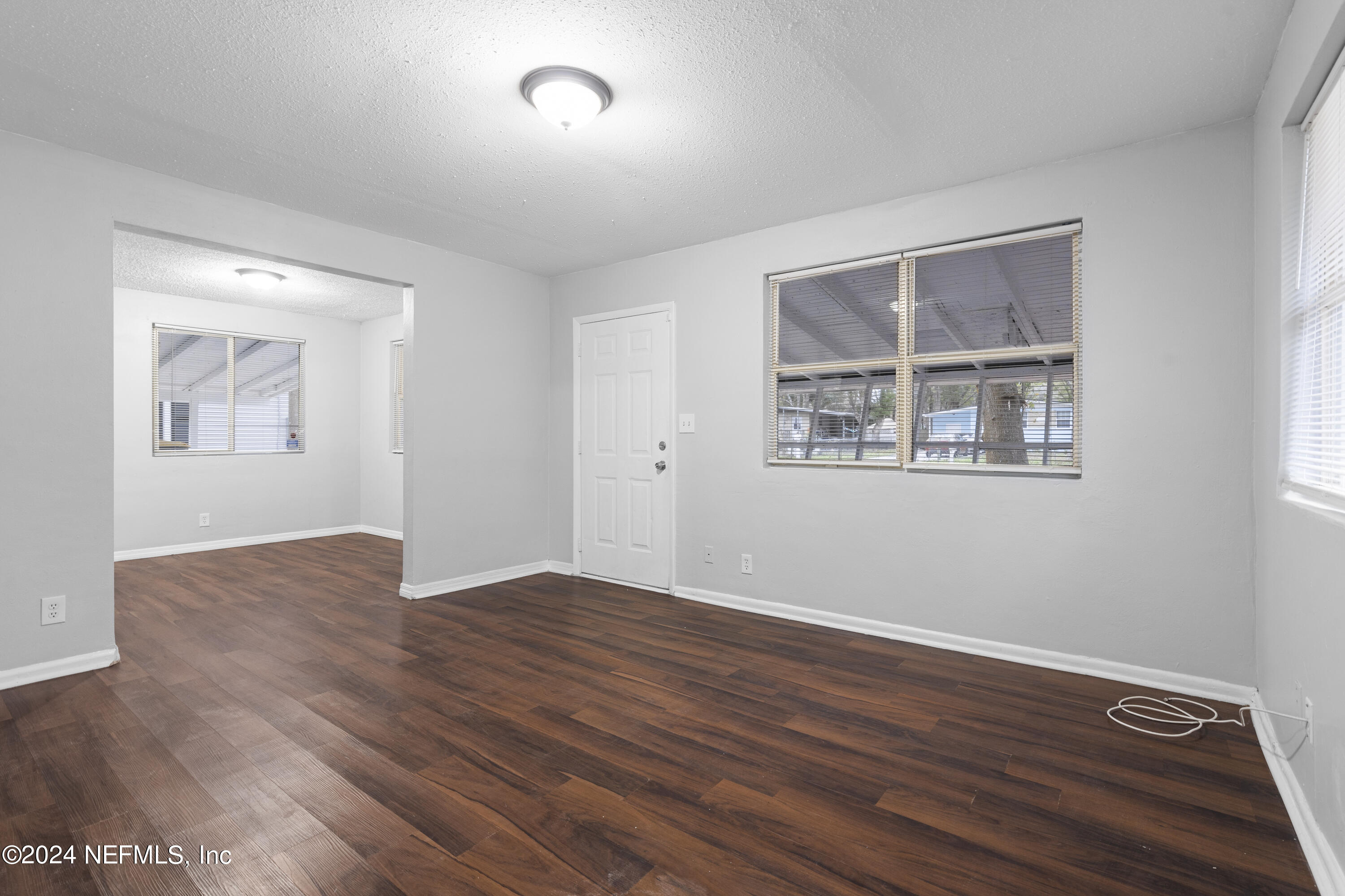 1174 Mohawk Street Jacksonville, FL 32205 - Photo 11 of 33 a view of an empty room with wooden floor and a window