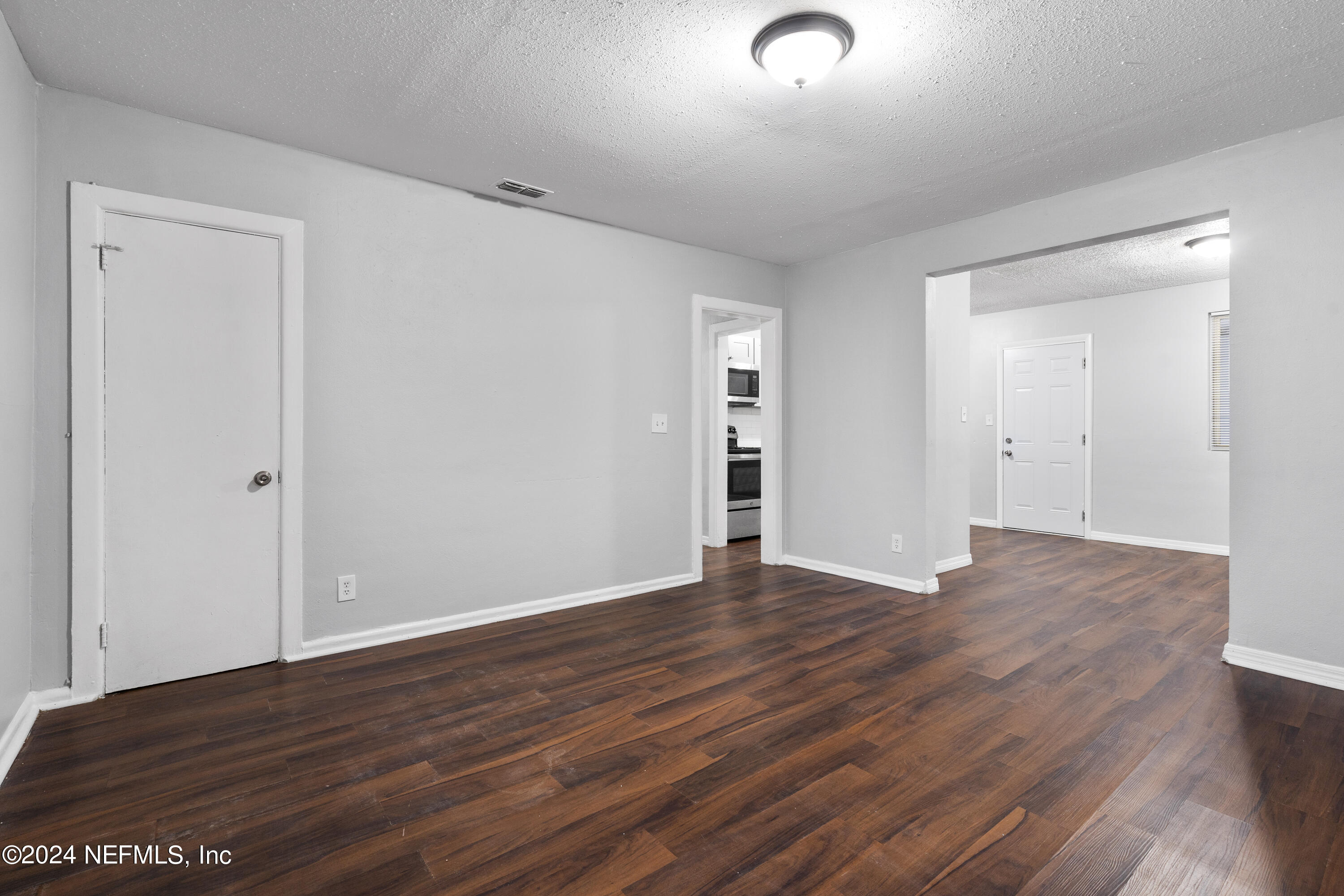 1174 Mohawk Street Jacksonville, FL 32205 - Photo 12 of 33 a view of an empty room with wooden floor