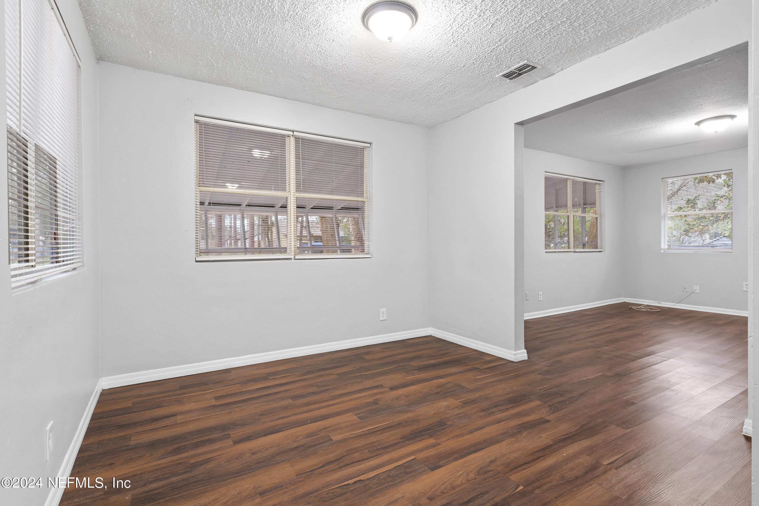 1174 Mohawk Street Jacksonville, FL 32205 - Photo 13 of 33 an empty room with wooden floor and windows