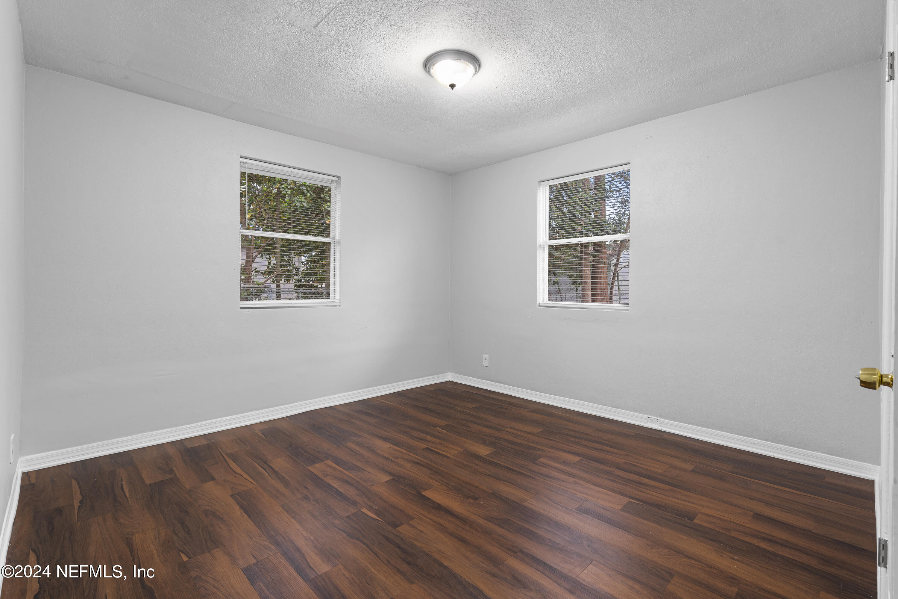 1174 Mohawk Street Jacksonville, FL 32205 - Photo 20 of 33 a view of an empty room with wooden floor and a window