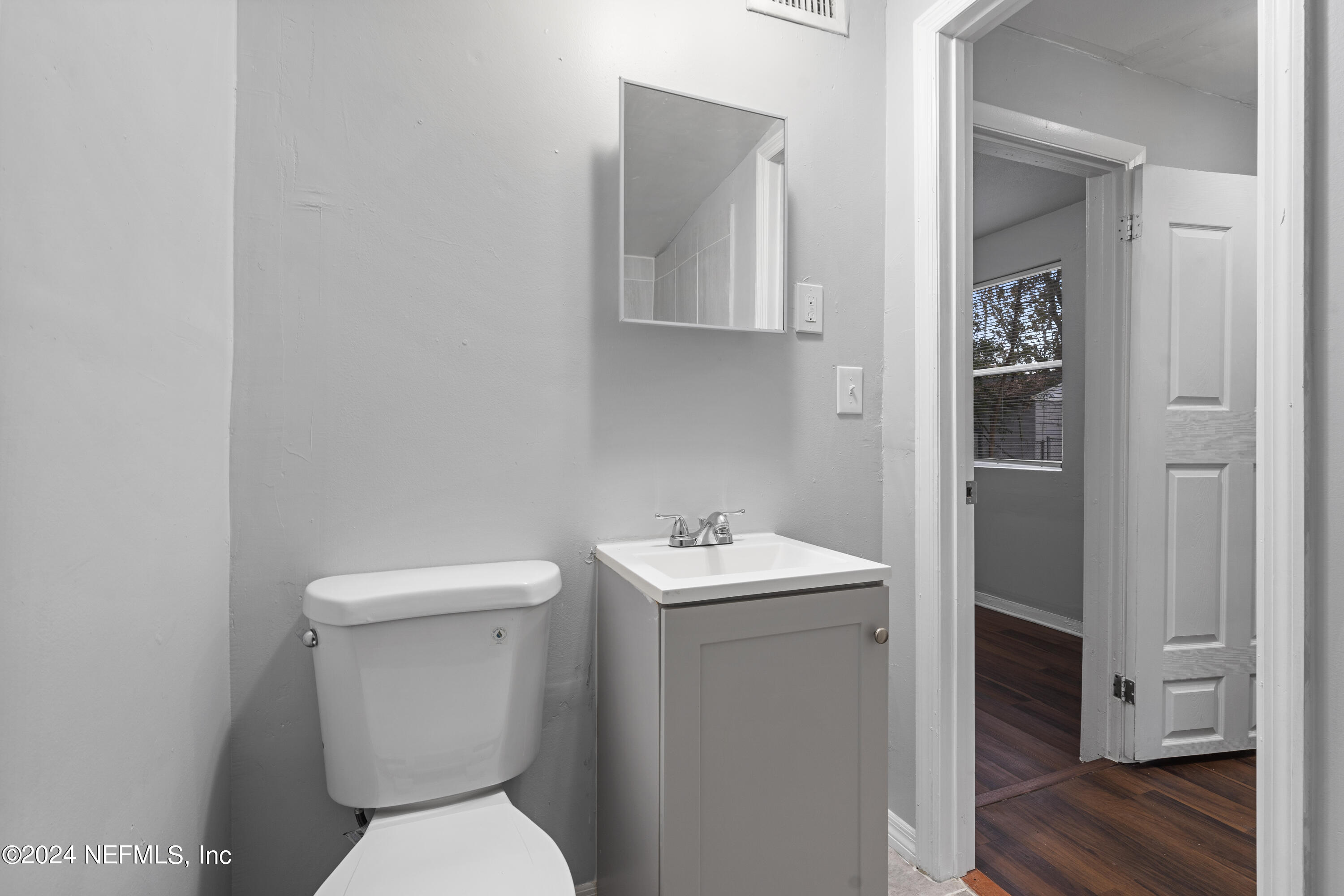 1174 Mohawk Street Jacksonville, FL 32205 - Photo 22 of 33 a white toilet sitting next to a bathroom sink
