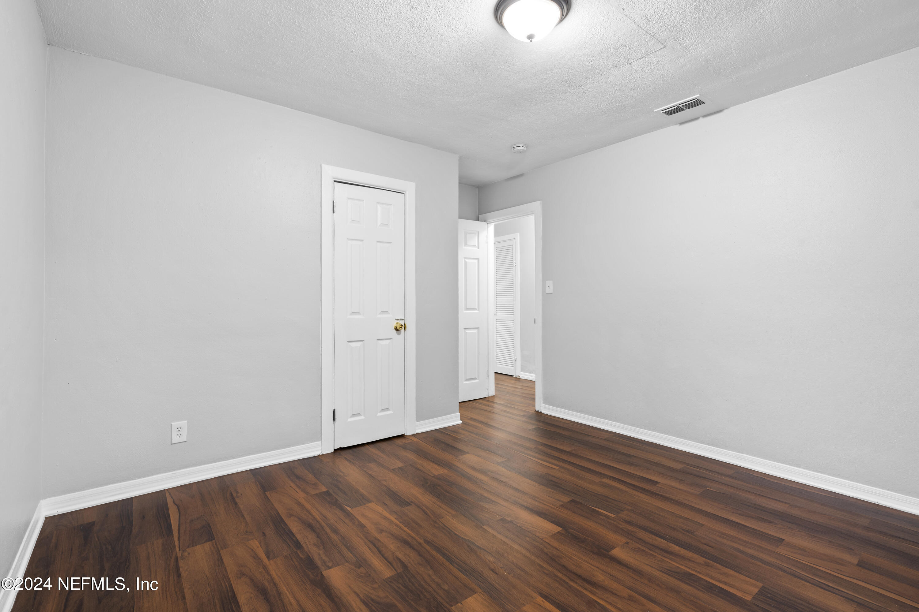 1174 Mohawk Street Jacksonville, FL 32205 - Photo 23 of 33 a view of an empty room with wooden floor