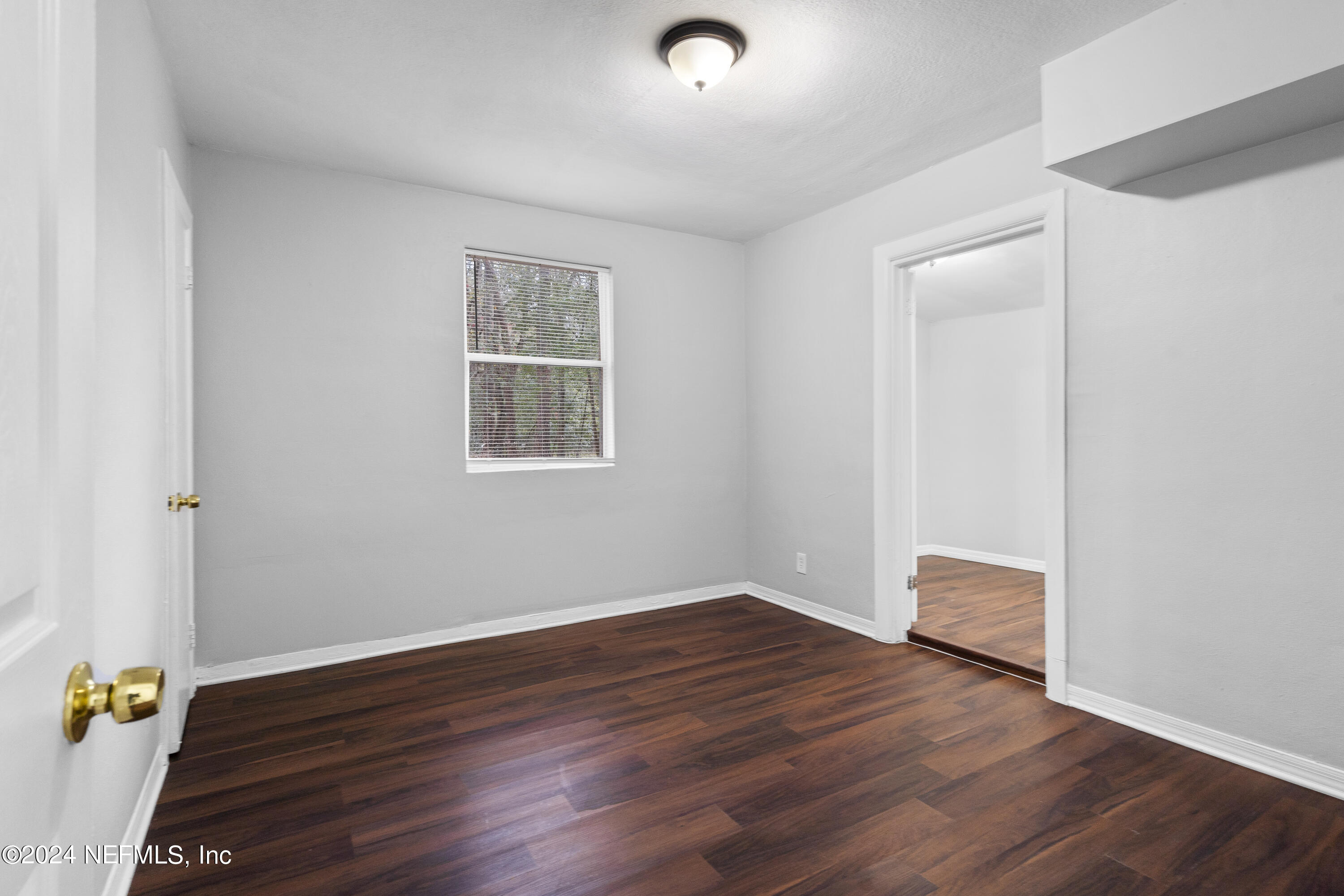 1174 Mohawk Street Jacksonville, FL 32205 - Photo 24 of 33 an empty room with wooden floor and windows