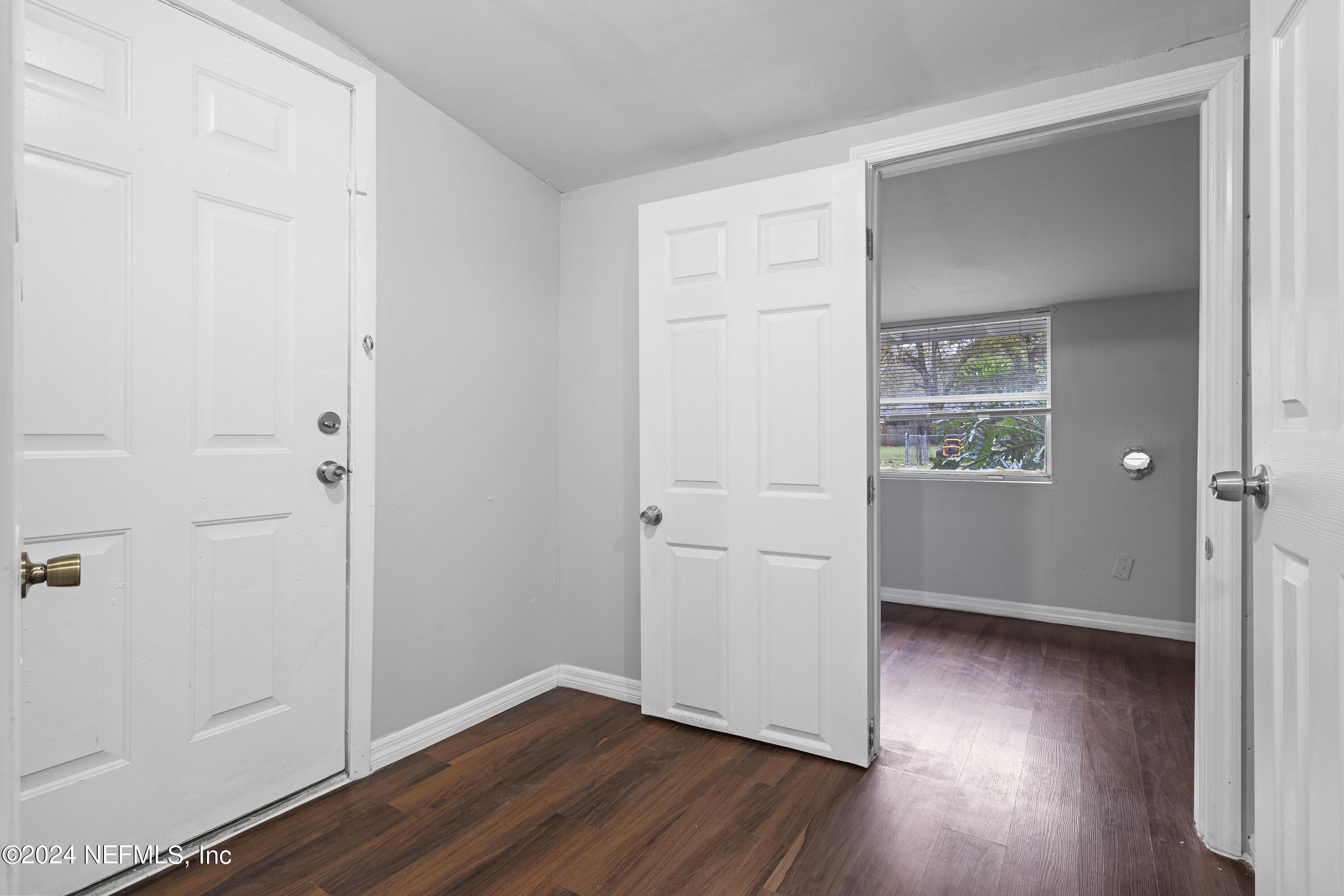 1174 Mohawk Street Jacksonville, FL 32205 - Photo 27 of 33 an empty room with wooden floor closet and windows