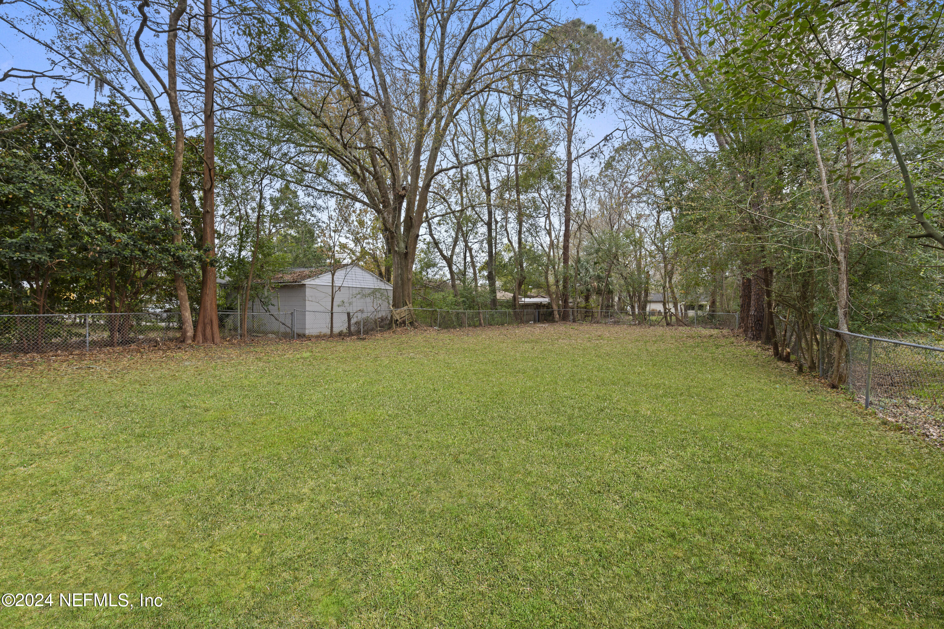 1174 Mohawk Street Jacksonville, FL 32205 - Photo 30 of 33 a view of a field with trees in front of the house