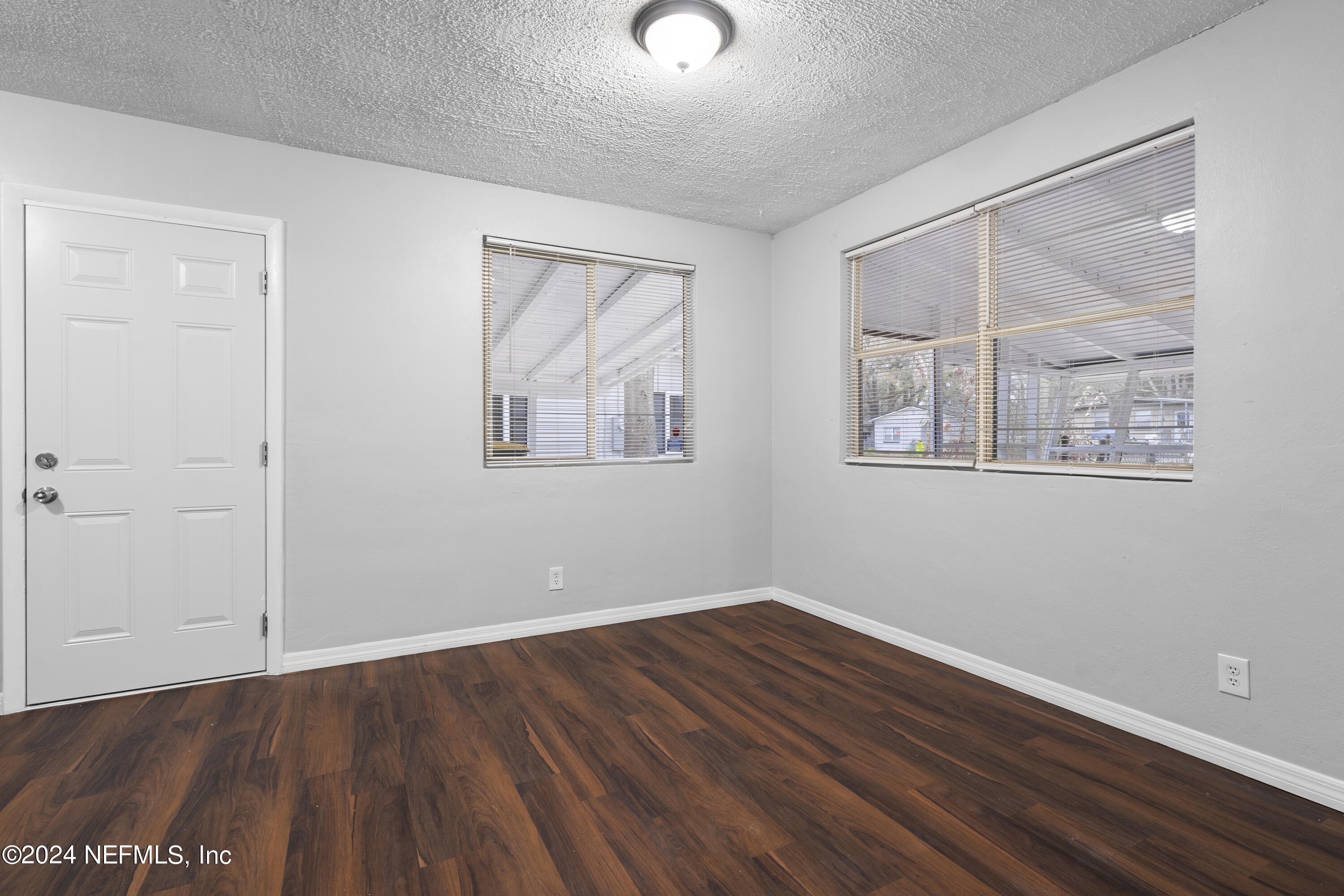 1174 Mohawk Street Jacksonville, FL 32205 - Photo 8 of 33 a view of empty room with wooden floor and fan