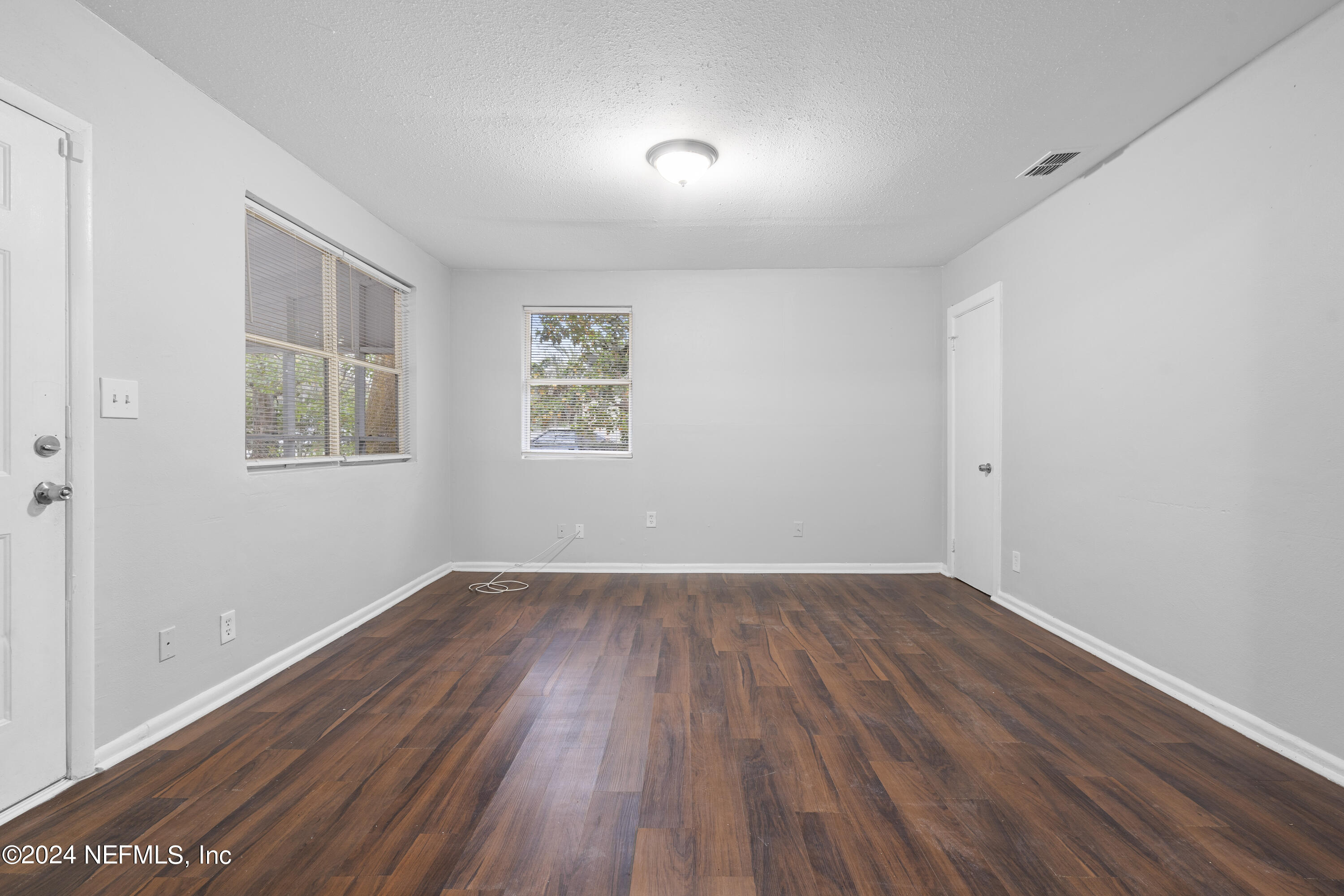 1174 Mohawk Street Jacksonville, FL 32205 - Photo 10 of 33 an empty room with wooden floor and windows