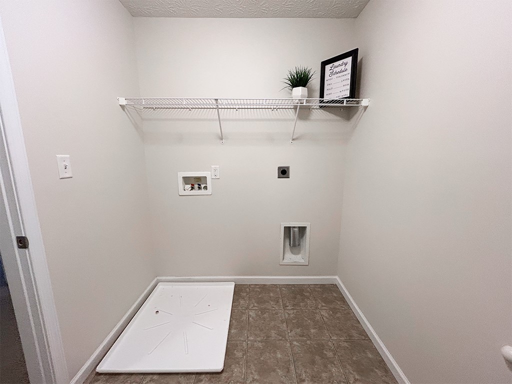 1978 Spring Ridge Drive Xenia, OH 45385 - Photo 27 of 44 Functional laundry room featuring a convenient shelf and durable tile flooring.