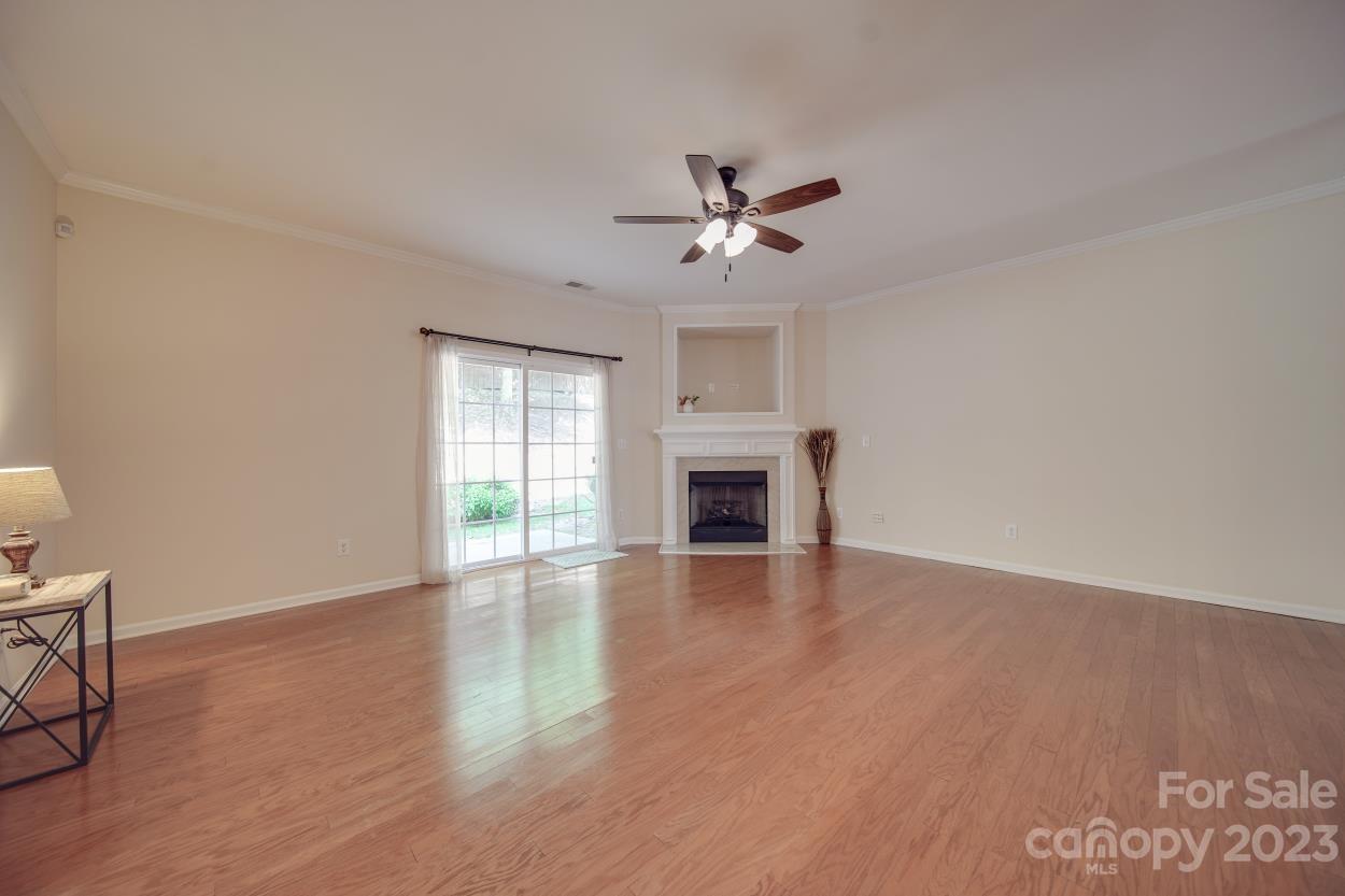 1919 Travertine Lane Fort Mill, SC 29708 - Photo 8 of 34 a view of empty room with wooden floor and fan