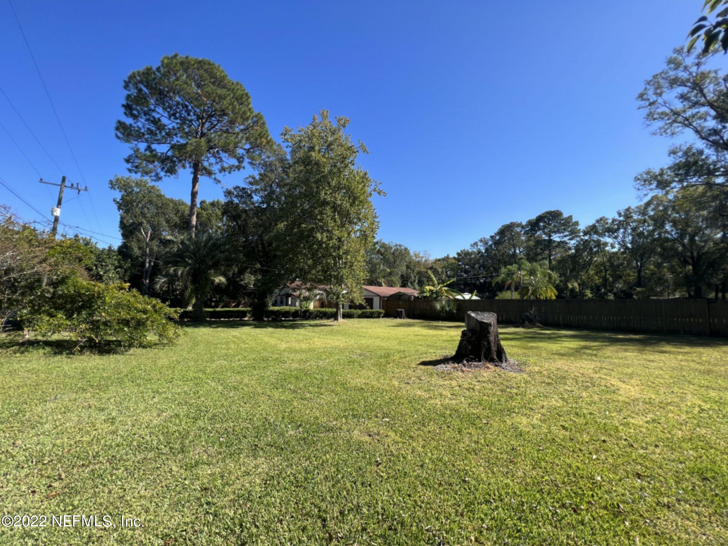 7044 Wheat Road Jacksonville, FL 32244 - Photo 5 of 32 a swimming pool with an outdoor seating and a garden