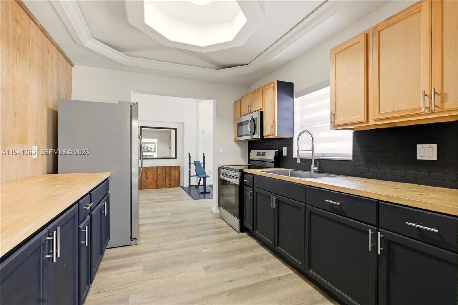 2124 Gardenview Road Sebring, FL 33870 - Photo 12 of 54 a large kitchen with stainless steel appliances granite countertop a sink and cabinets