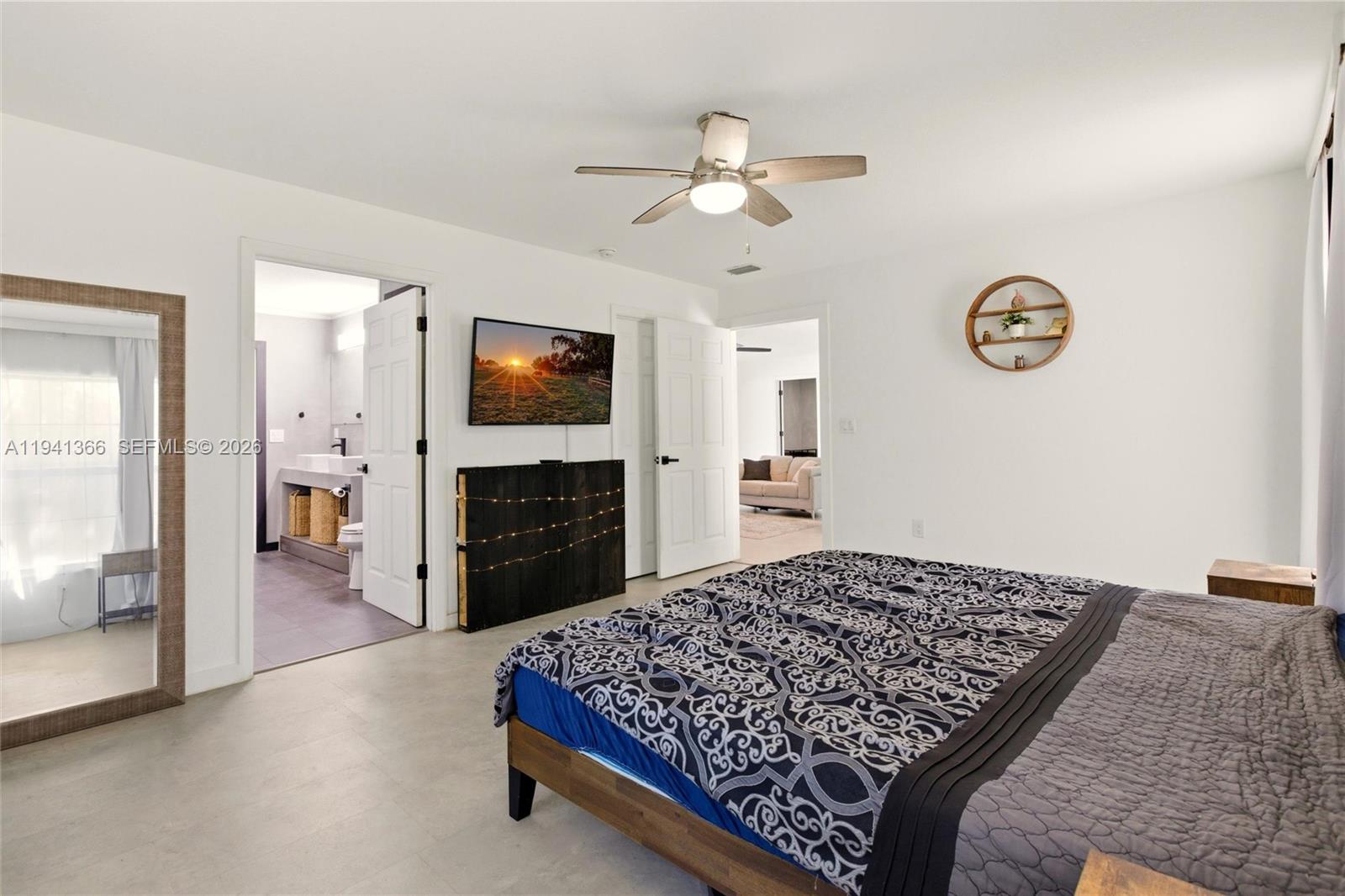 2124 Gardenview Road Sebring, FL 33870 - Photo 18 of 54 a bedroom with a large bed and a chandelier