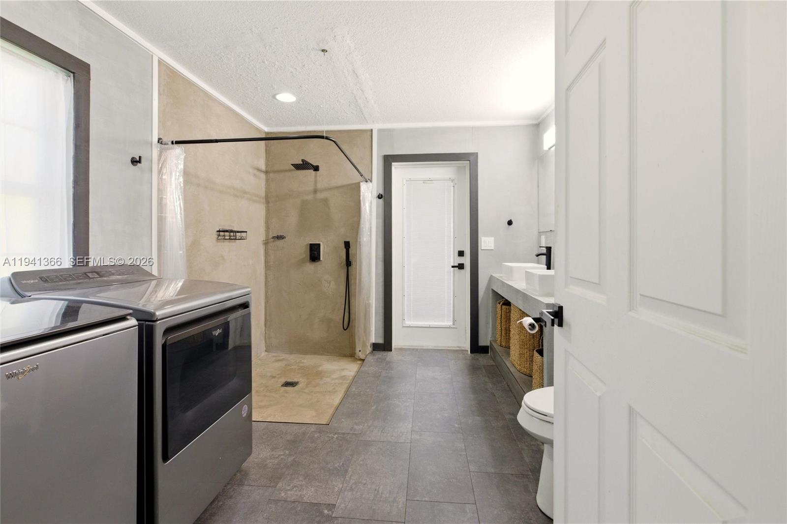 2124 Gardenview Road Sebring, FL 33870 - Photo 20 of 54 a spacious bathroom with a granite countertop sink a mirror and a toilet