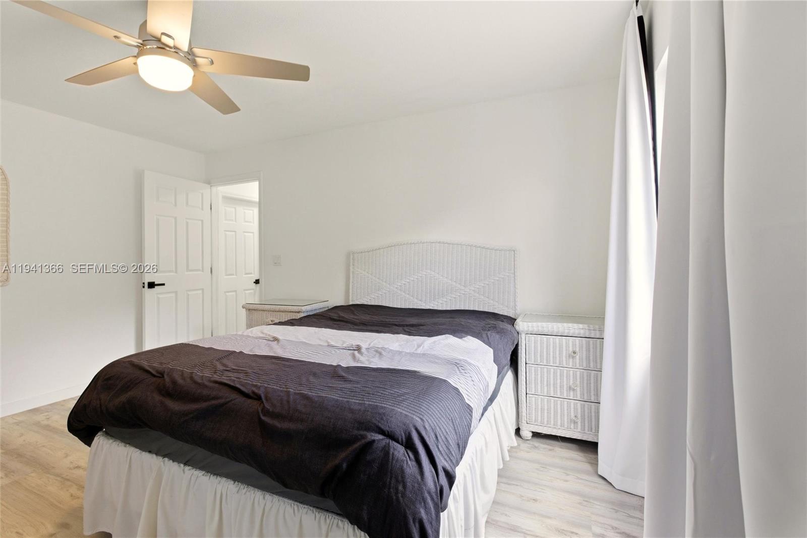 2124 Gardenview Road Sebring, FL 33870 - Photo 24 of 54 a bedroom with a bed and a chandelier
