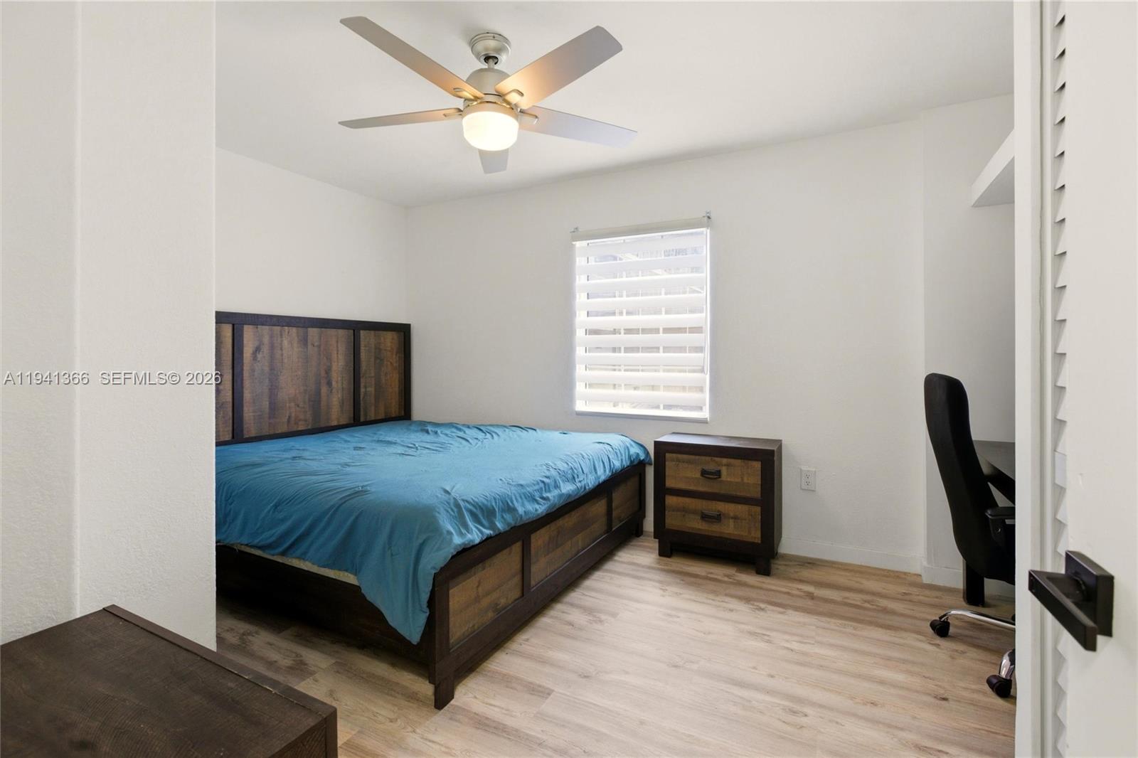 2124 Gardenview Road Sebring, FL 33870 - Photo 25 of 54 a bedroom with a bed and wooden floor