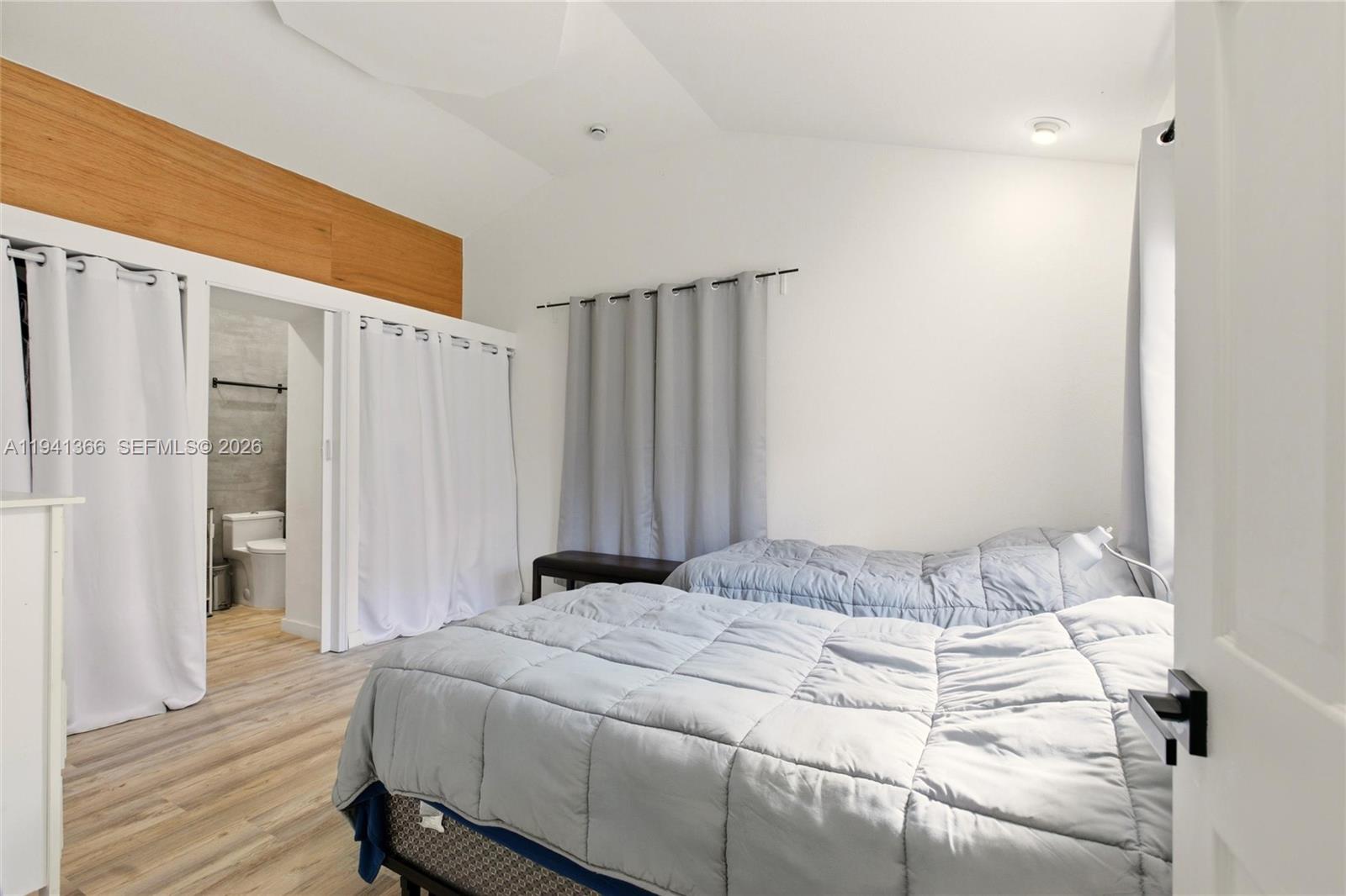 2124 Gardenview Road Sebring, FL 33870 - Photo 37 of 54 a bedroom with a bed and wooden floor