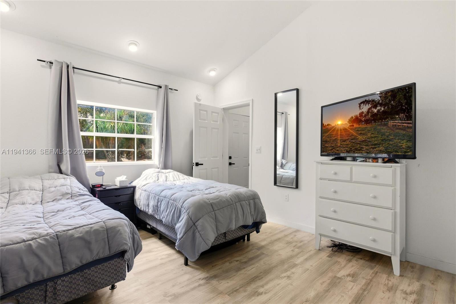 2124 Gardenview Road Sebring, FL 33870 - Photo 39 of 54 a bedroom with two beds and a flat screen tv