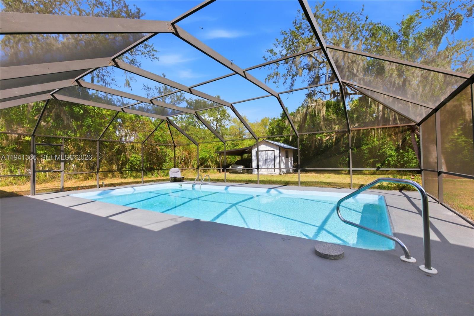 2124 Gardenview Road Sebring, FL 33870 - Photo 42 of 54 a view of a swimming pool with a bench in patio
