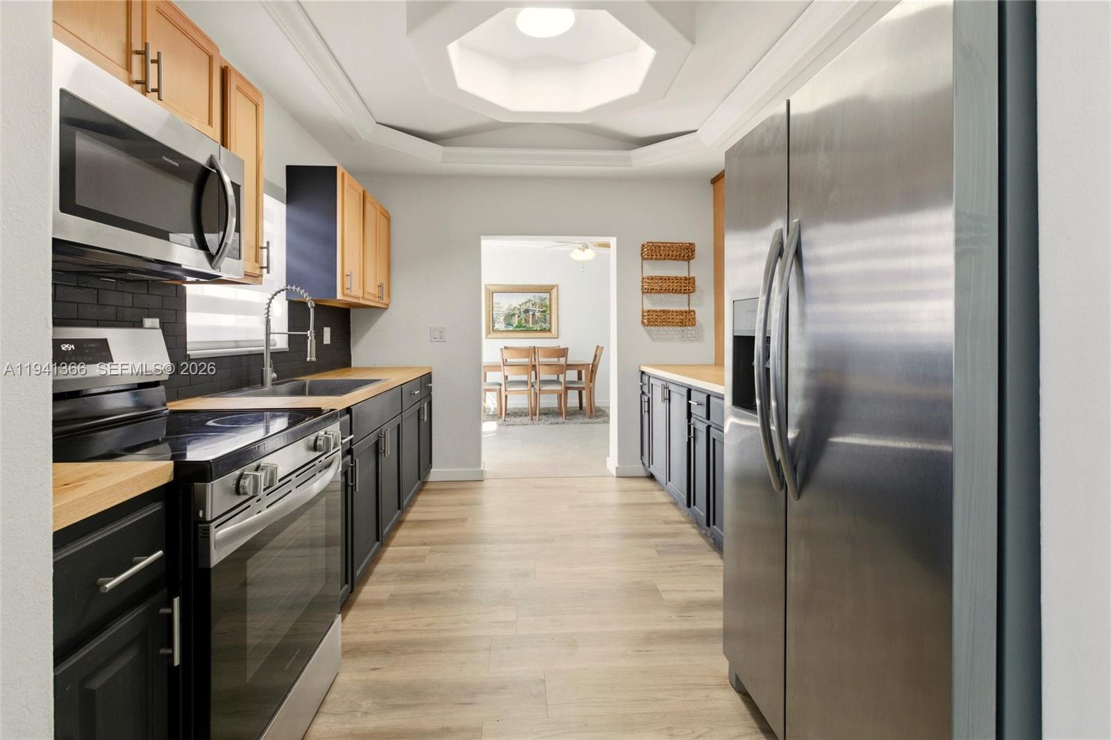 2124 Gardenview Road Sebring, FL 33870 - Photo 9 of 54 a kitchen with stainless steel appliances granite countertop a refrigerator a stove and a sink