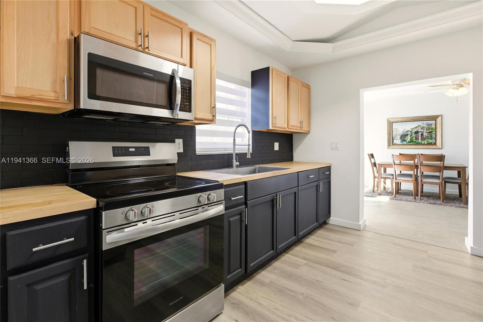 2124 Gardenview Road Sebring, FL 33870 - Photo 10 of 54 a kitchen with stainless steel appliances a stove microwave and cabinets
