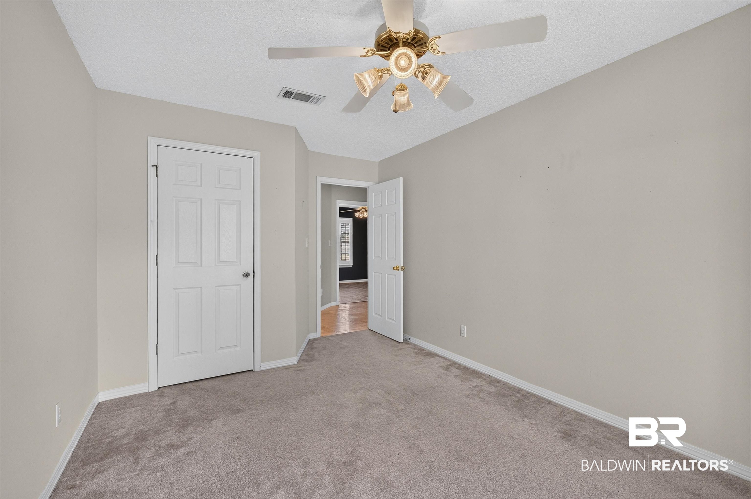 22685 County Road 12 Foley, AL 36535 - Photo 60 of 89 Carpeted room featuring a ceiling fan with integrated lighting, neutral wall tones, and white trim