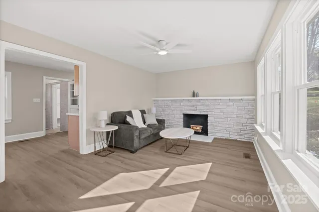 a living room with furniture and a fireplace