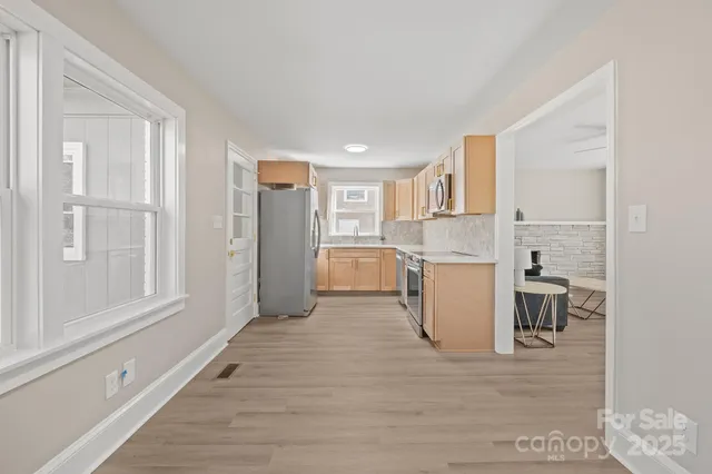 a kitchen with a refrigerator stove and a sink