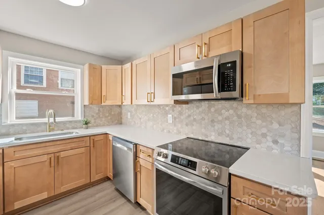a kitchen with a sink stove and microwave