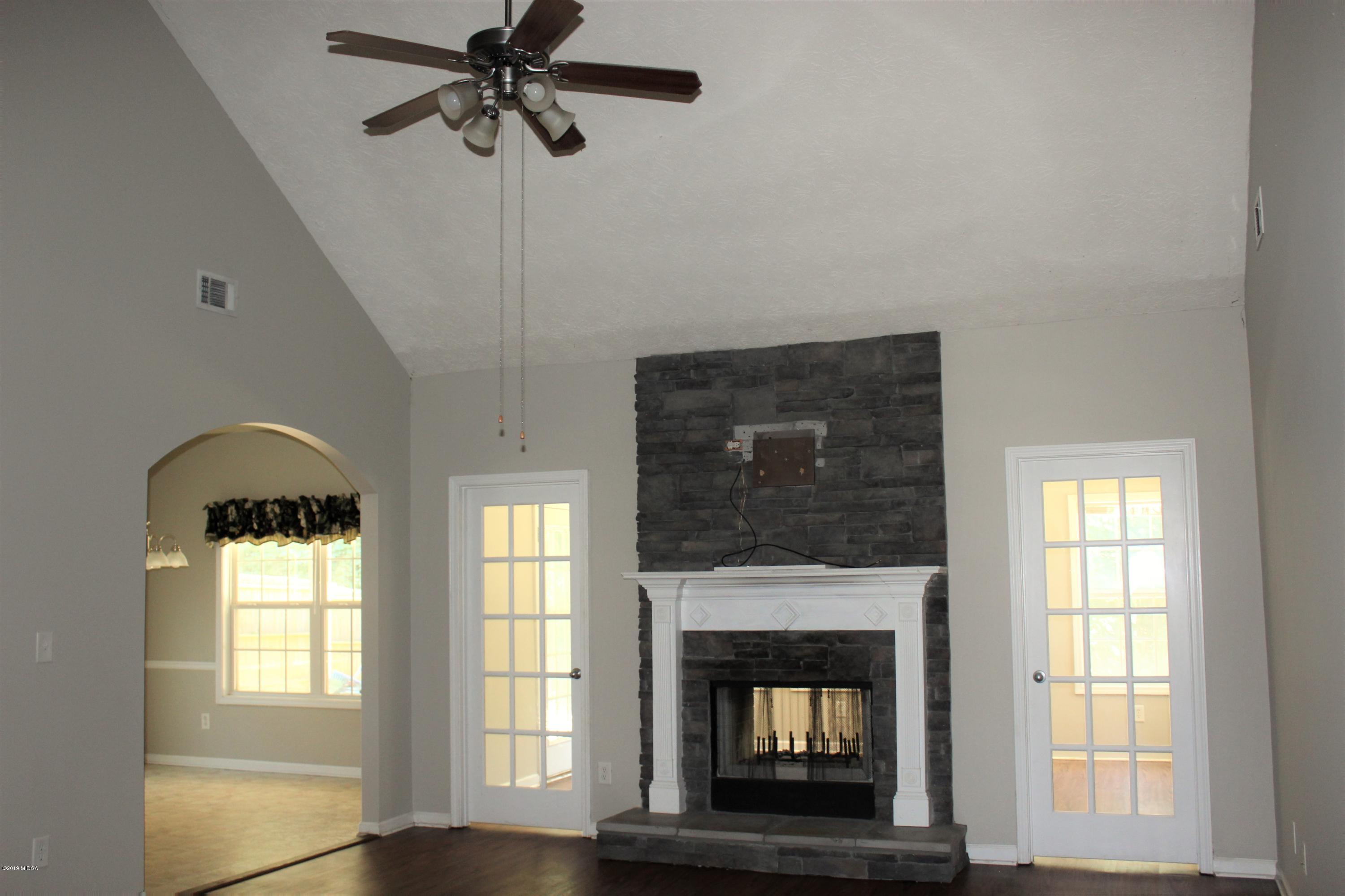 318 Hickory Road Jackson, GA 30233 - Photo 2 of 13 a living room with a fireplace and windows