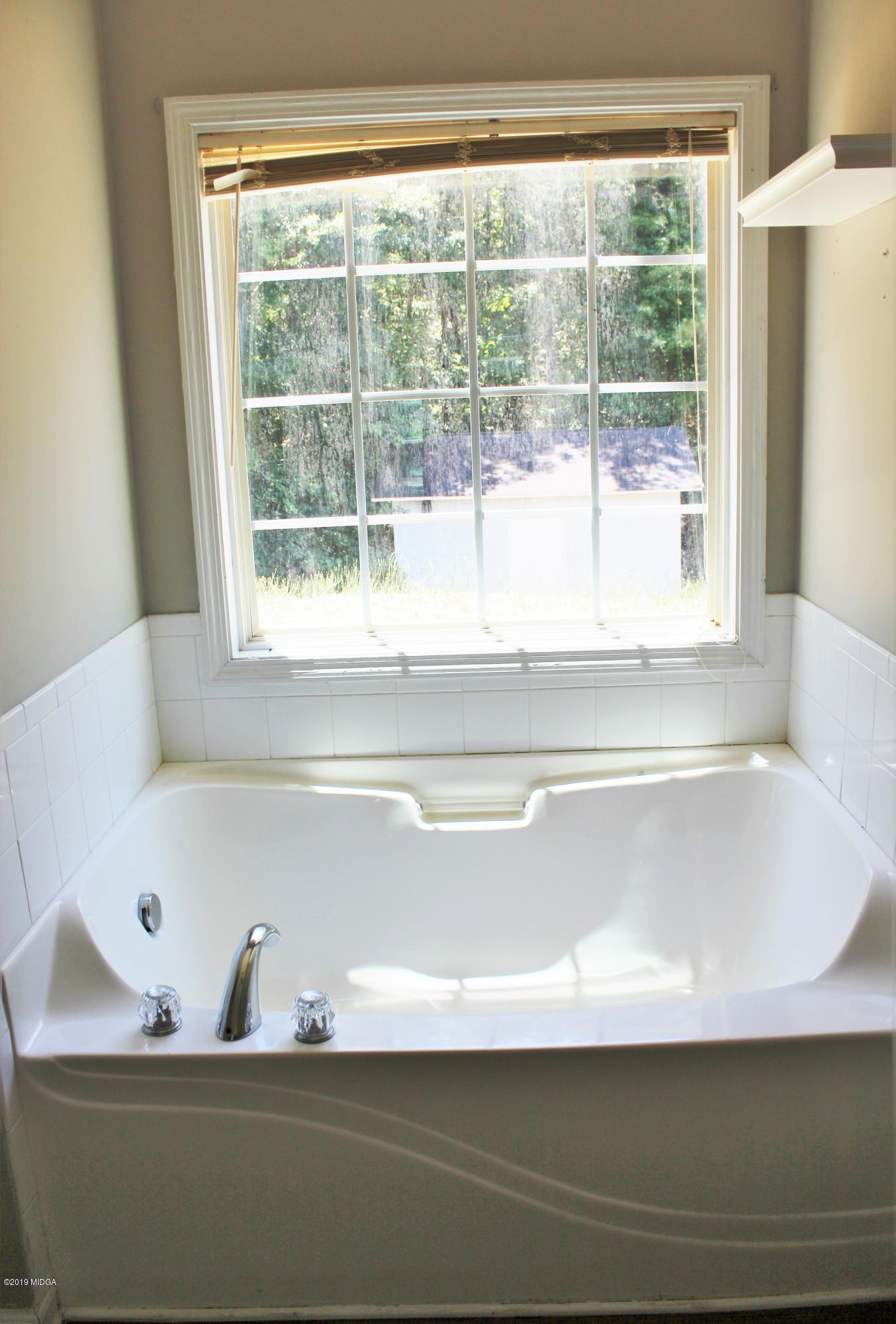 318 Hickory Road Jackson, GA 30233 - Photo 12 of 13 a view of a bath tub sitting in a bathroom