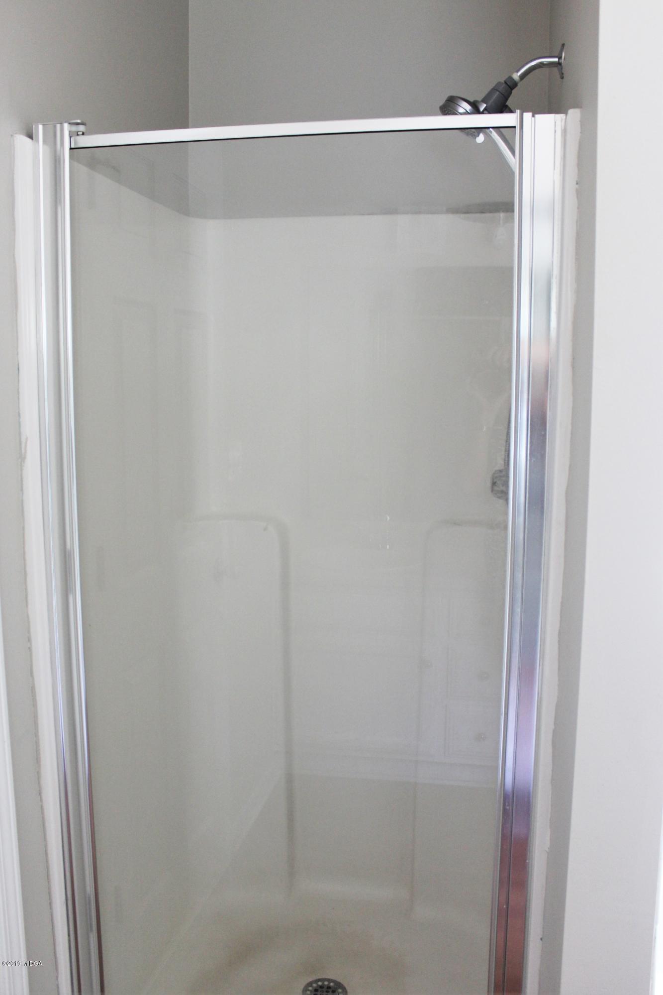 318 Hickory Road Jackson, GA 30233 - Photo 13 of 13 a bathroom with a glass shower door