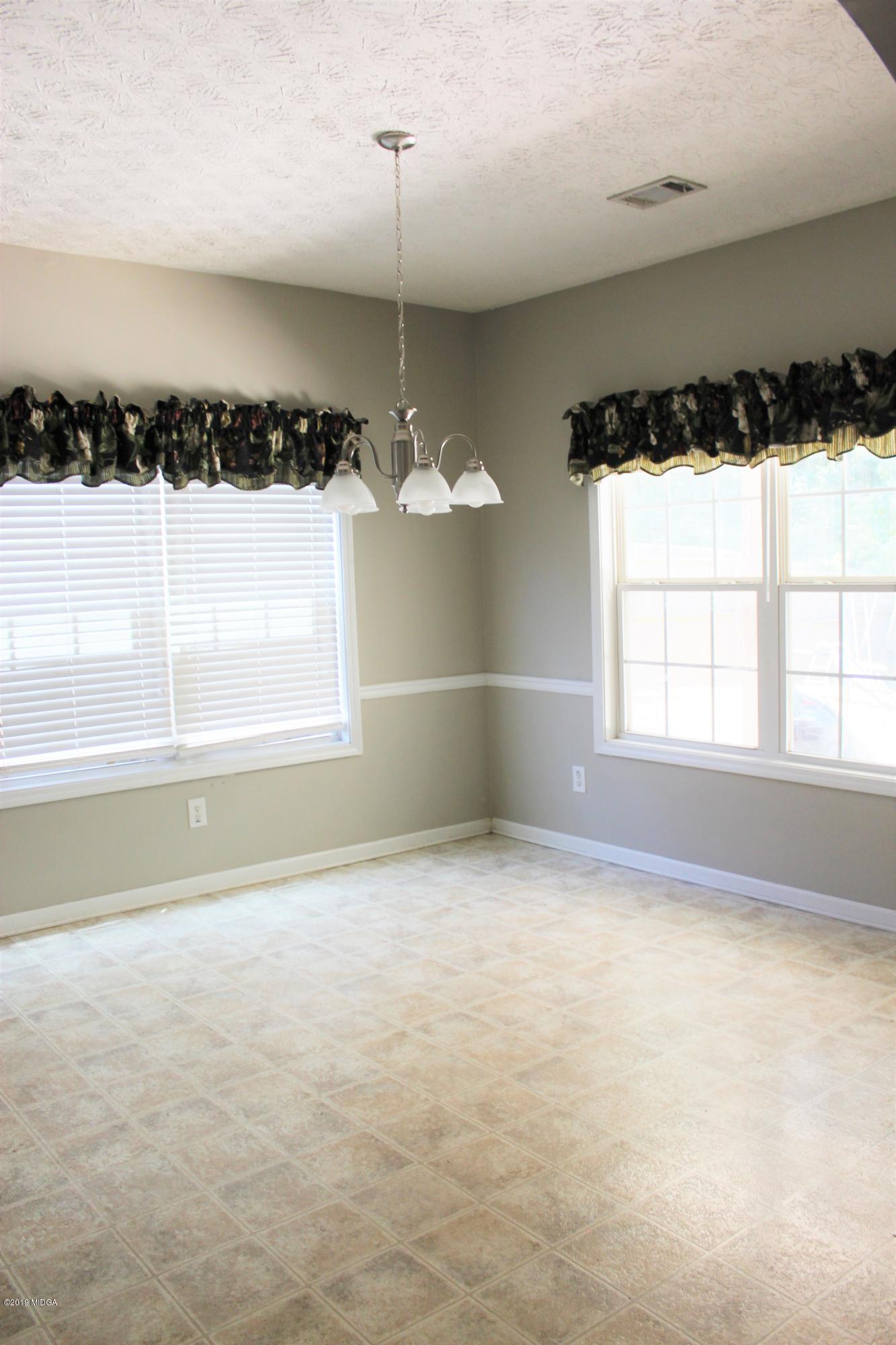318 Hickory Road Jackson, GA 30233 - Photo 3 of 13 a view of a room with a large window and chandelier