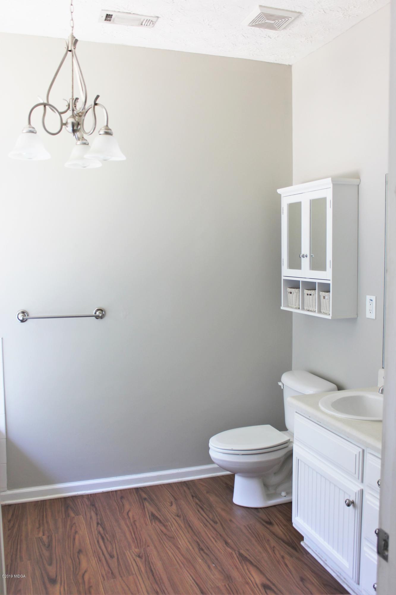 318 Hickory Road Jackson, GA 30233 - Photo 10 of 13 a white toilet sitting next to a bathroom sink