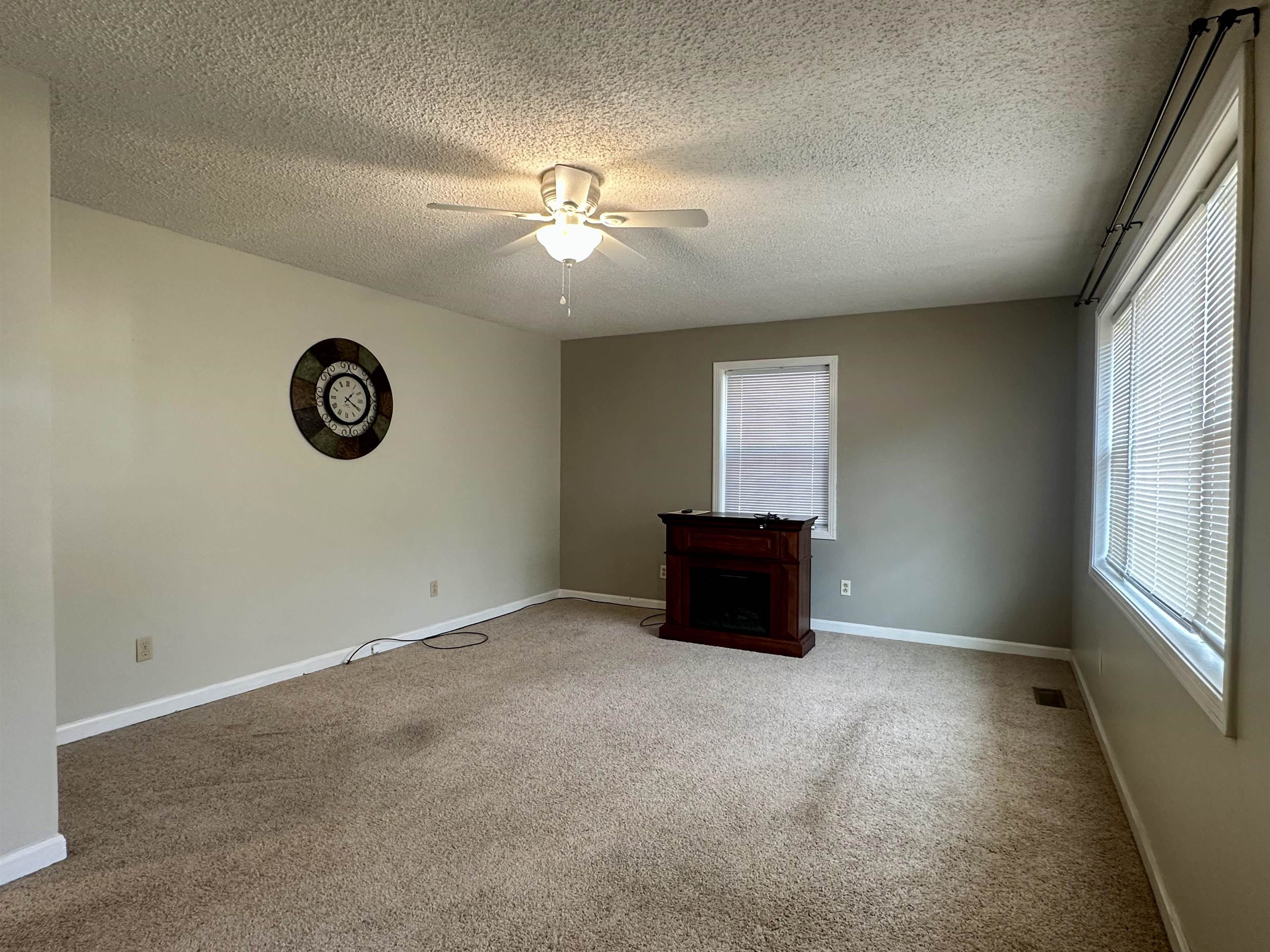 170 Mitchell Street Selmer, TN 38375 - Photo 11 of 26 an empty room with windows and fan