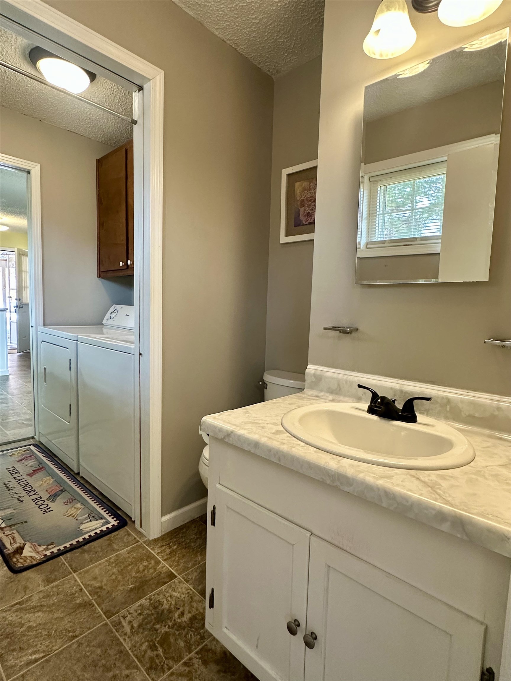 170 Mitchell Street Selmer, TN 38375 - Photo 12 of 26 a bathroom with a sink vanity and a mirror