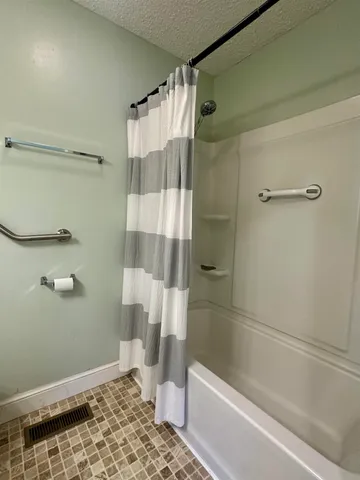 a bathroom with a shower and a toilet