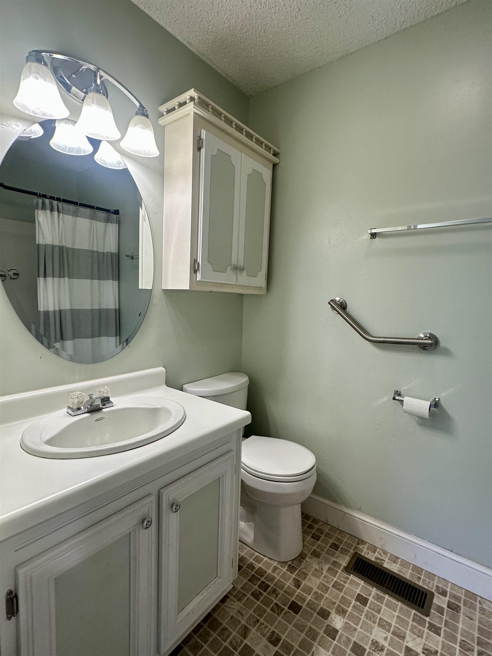 170 Mitchell Street Selmer, TN 38375 - Photo 17 of 26 a bathroom with a sink toilet and mirror